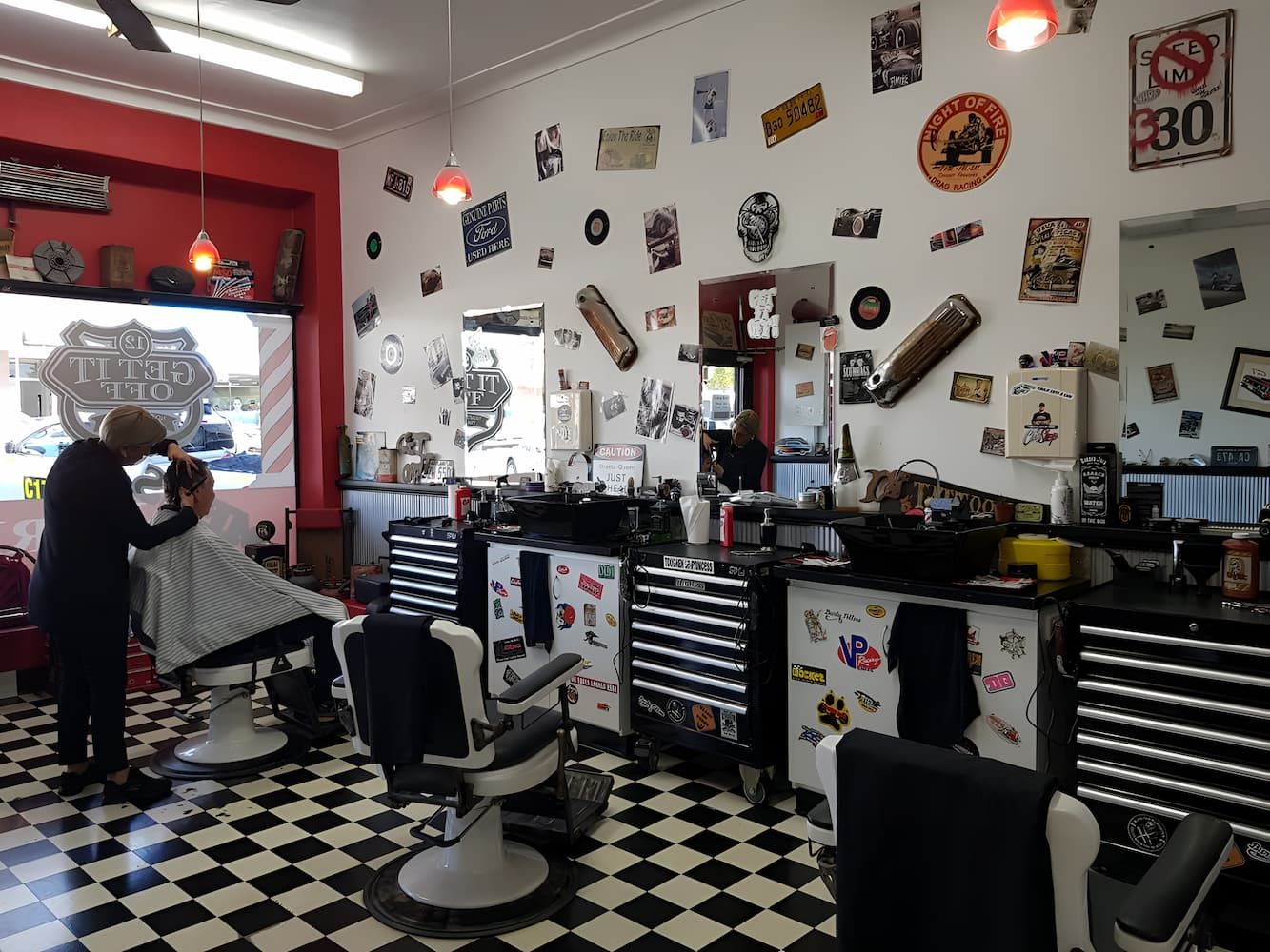 A Man Is Getting His Hair Cut In A Barber Shop — Get It Off Men's Barber Shop In Raymond Terrace, NSW