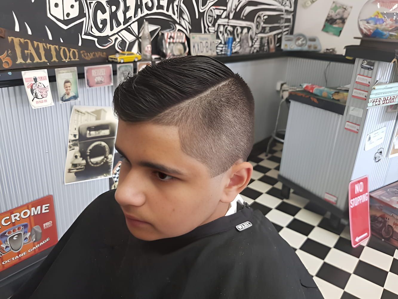 A Young Boy Is Getting His Hair Cut At A Barber Shop — Get It Off Men's Barber Shop In Raymond Terrace, NSW