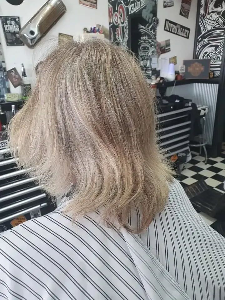 A Woman Is Getting Her Hair Cut At A Barber Shop — Get It Off Men's Barber Shop In Raymond Terrace, NSW