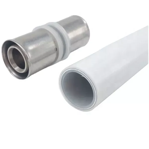 A stainless steel pipe fitting next to a white plastic pipe.