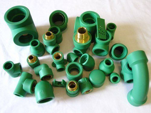 Green polypropylene plumbing fittings with brass connections.