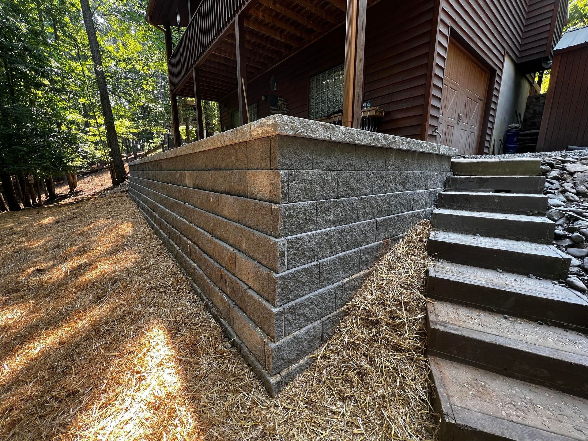 Stairs leading up to a house with a brick wall