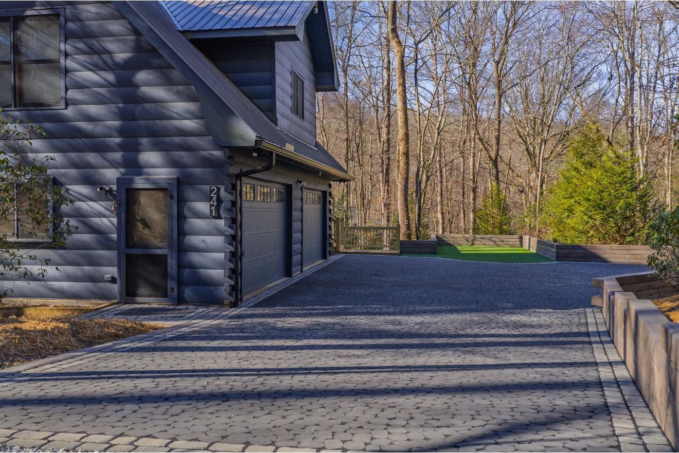 A group of people are sitting around a fire pit on a patio.