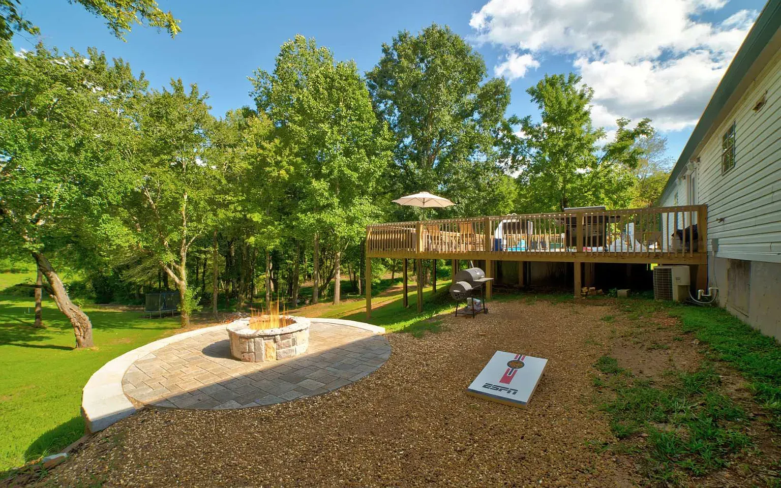 a house with a large deck and a fire pit