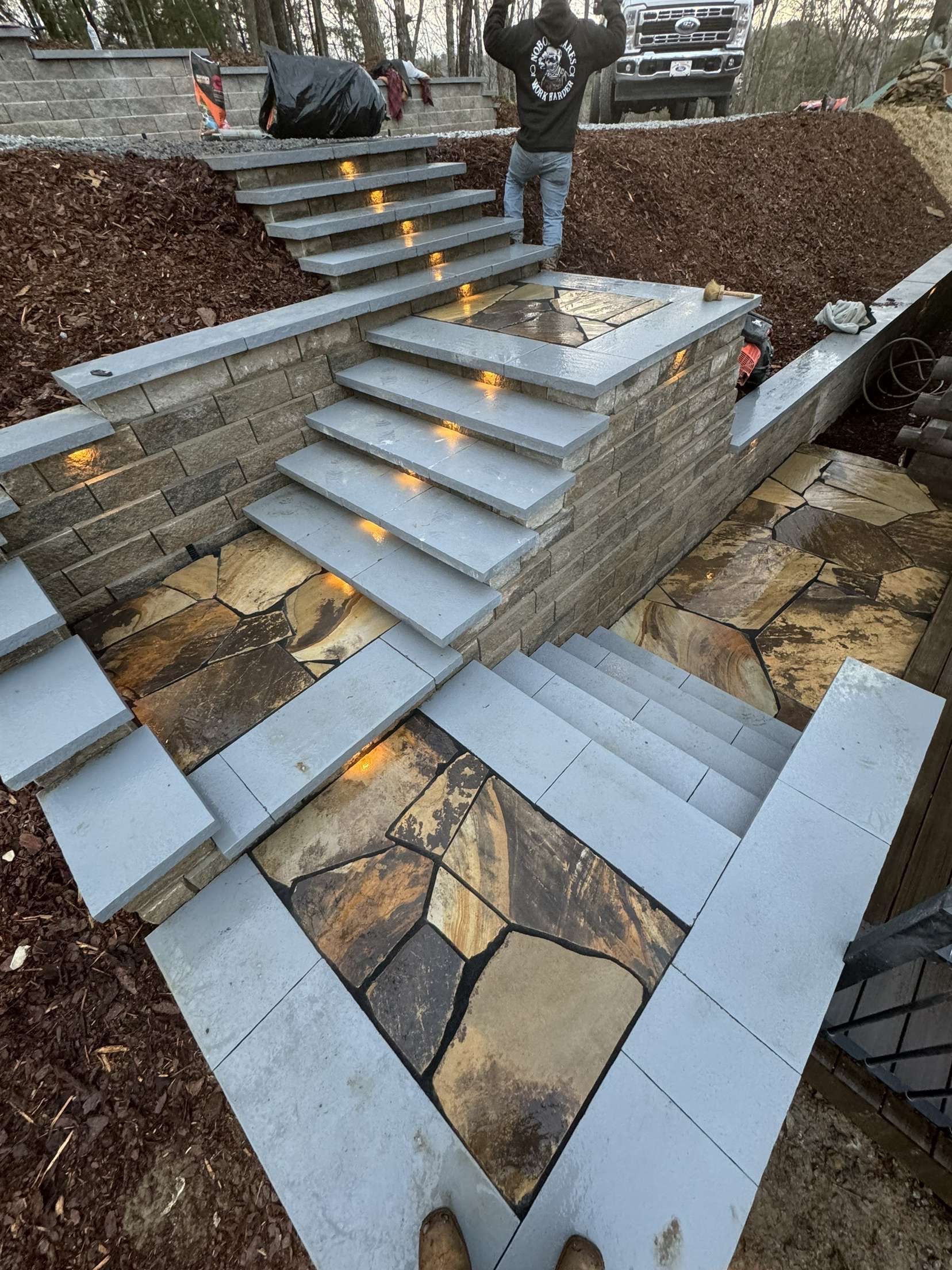 A man in a black shirt is standing on a set of stairs