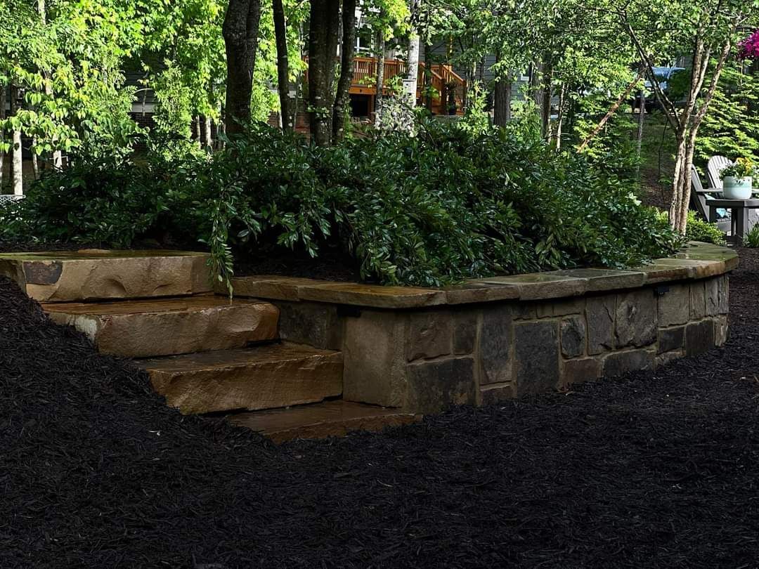 A stone wall with stairs leading up to it