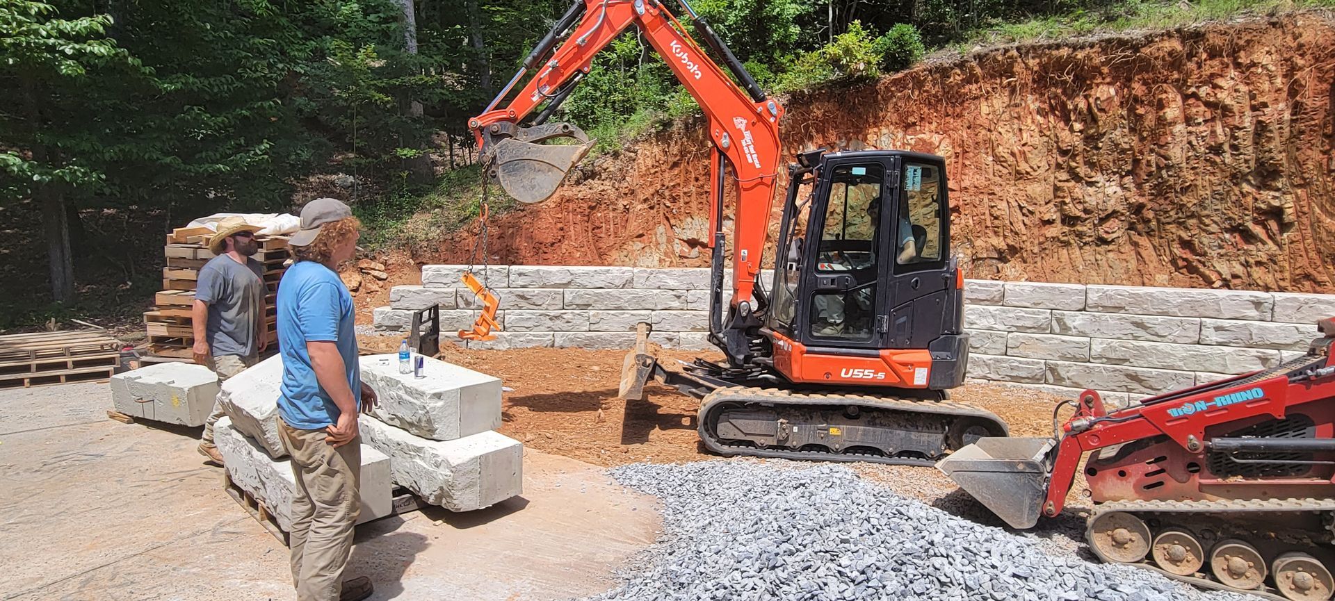 a man is standing in front of a construction site with a bulldozer .
