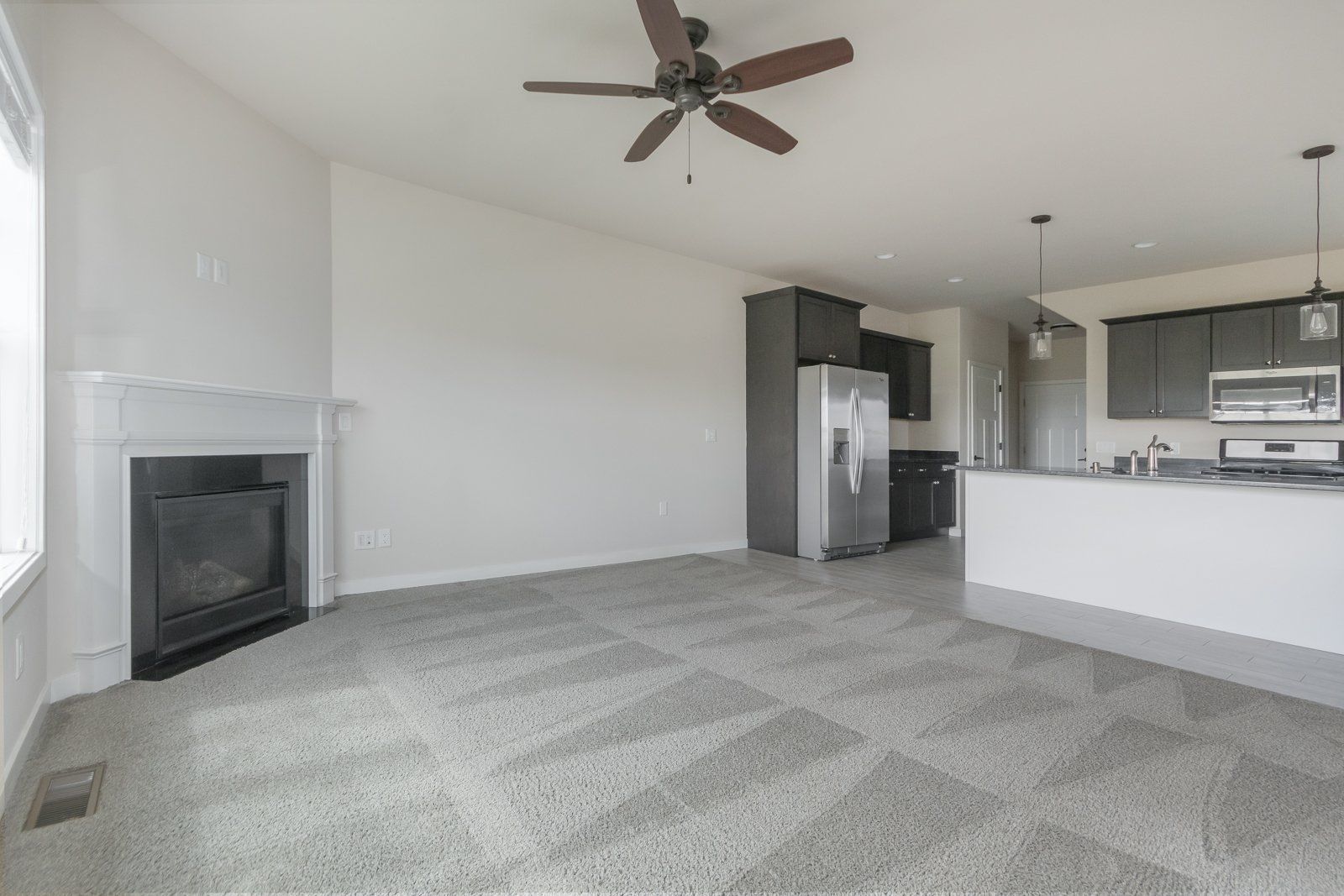 Aspire Homes living room with fireplace and fan