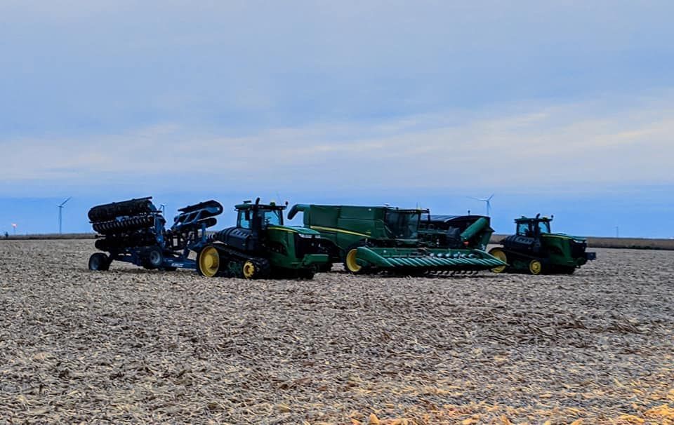 A group of tractors are sitting in a field.
