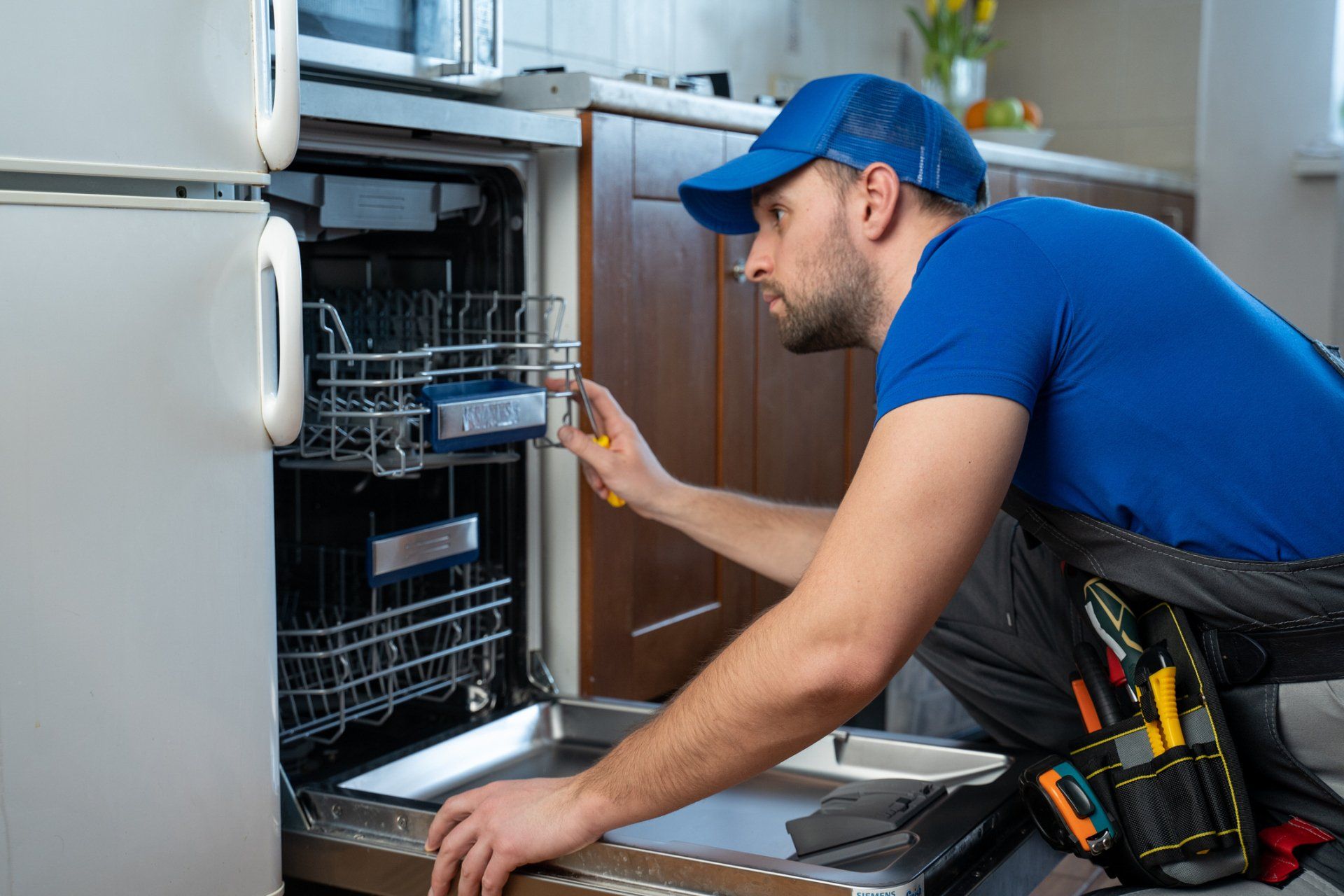 Repairman Repairing Dishwasher — Nashville, TN — Action Appliance Repair Service