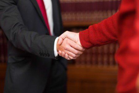 Businessman giving an handshake — Attorneys in East Longmeadow, MA