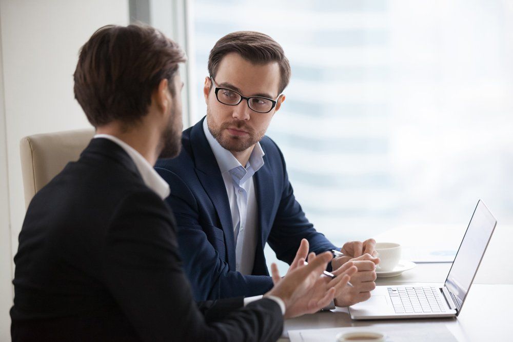 Practitioner — Two Young Businessmen Discuss The Plan Project In Office in Syracuse, UT Practitioner — Two Young Businessmen Discuss The Plan Project In Office in Syracuse, UT