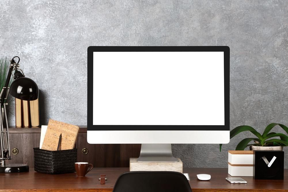 A Computer With a White Screen is Sitting on a Wooden Desk — Leading Edge Computers in Forster, NSW