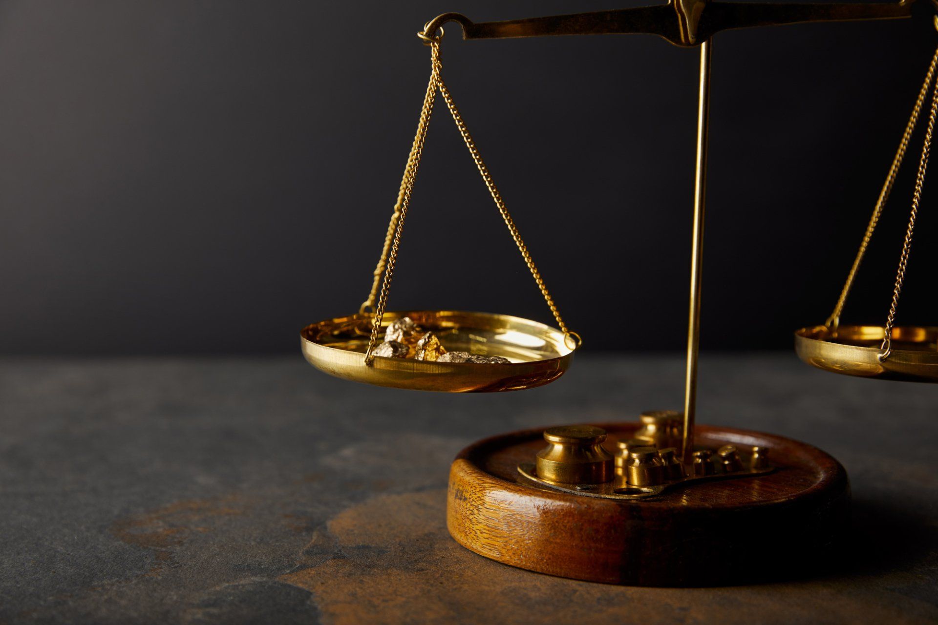 A close up of a scale of justice on a table.