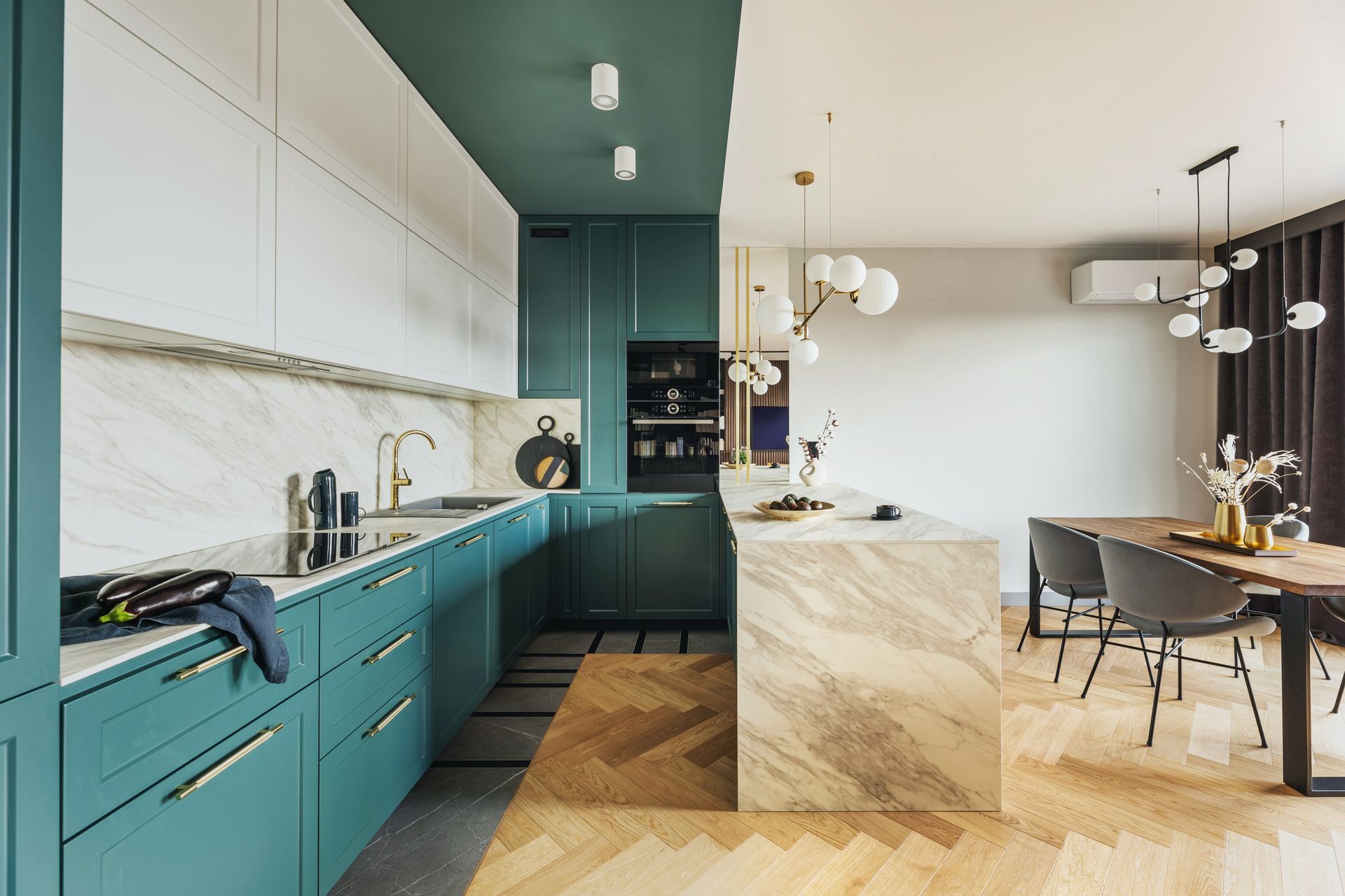 A kitchen with green cabinets and white cabinets and a wooden floor.