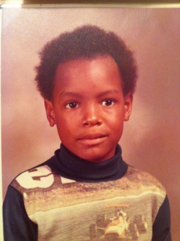A young boy wearing a shirt with the number 3 on it