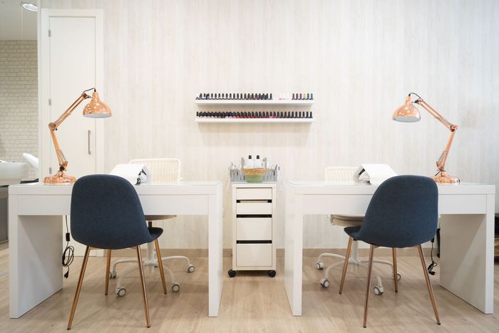 Two tables with chairs and lamps in a room