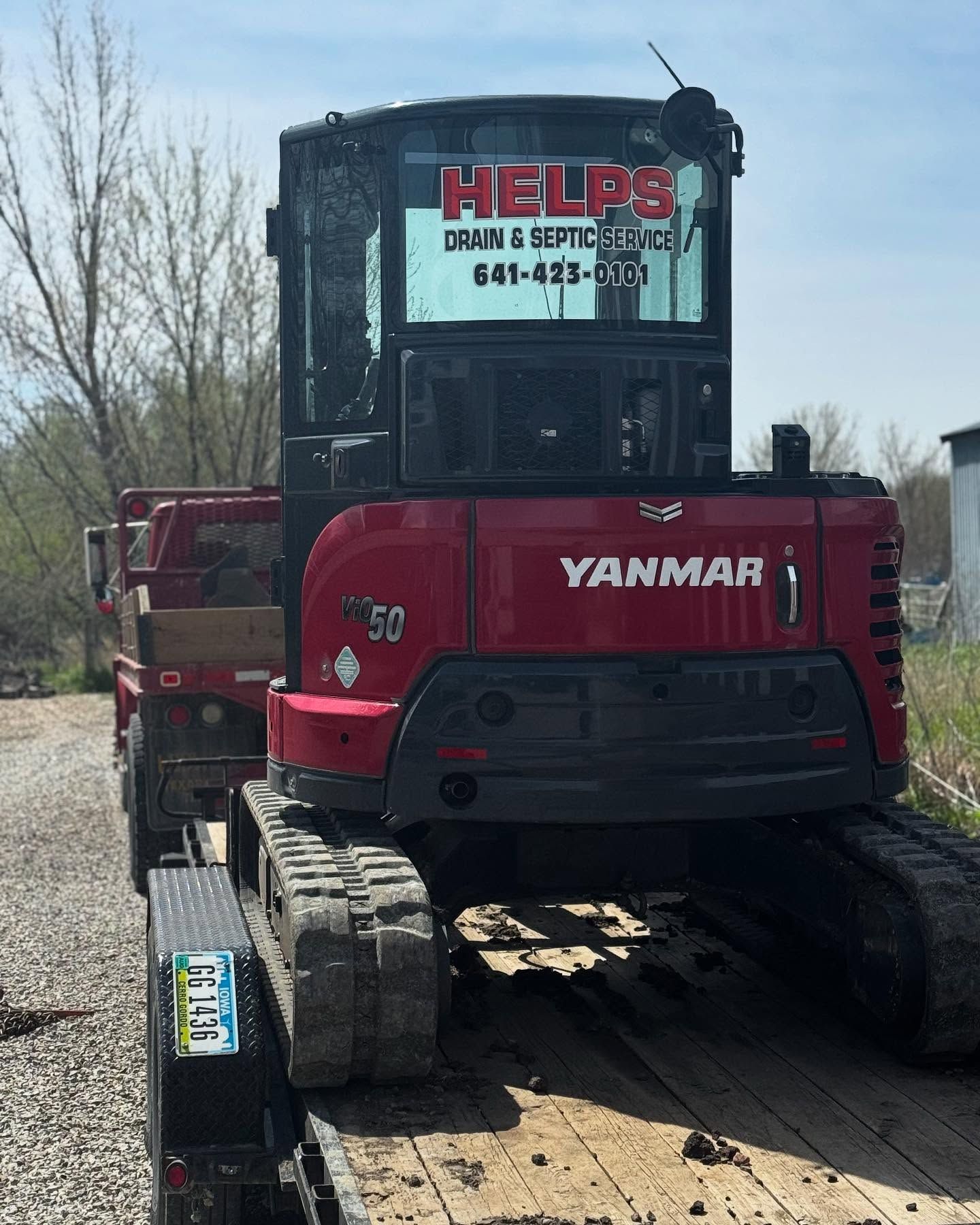 Red Yanmar excavator on a trailer with 