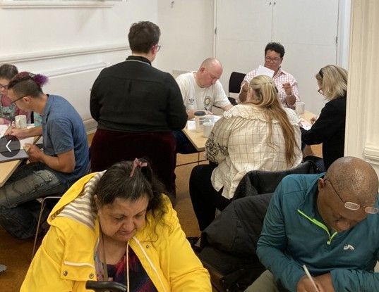 A group of people are sitting at tables in a room