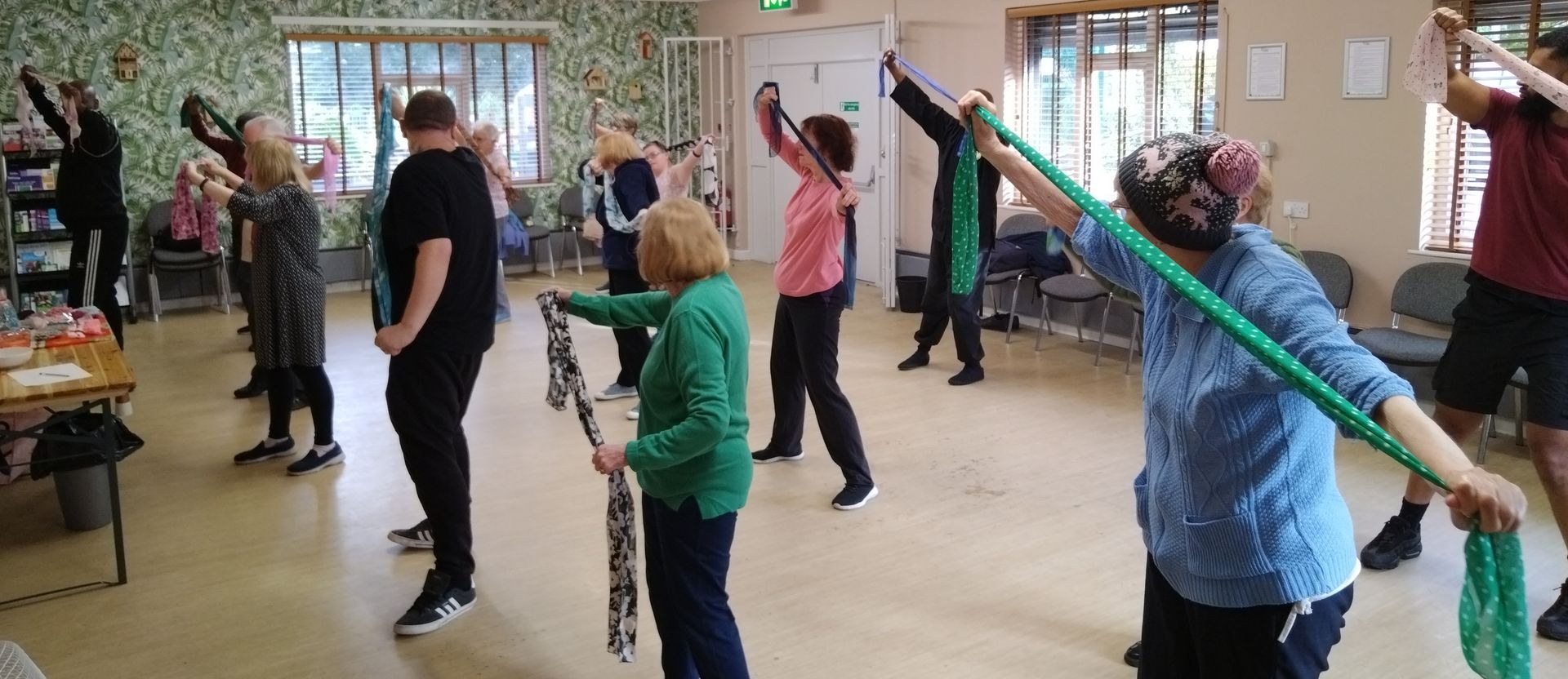 A group of people are doing exercises in a room.