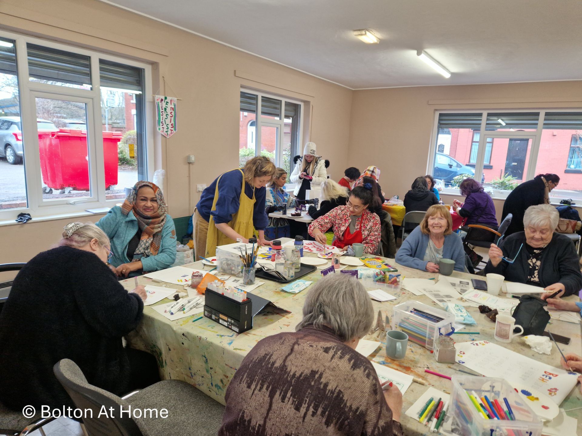 A group of people are sitting around a table in a room.