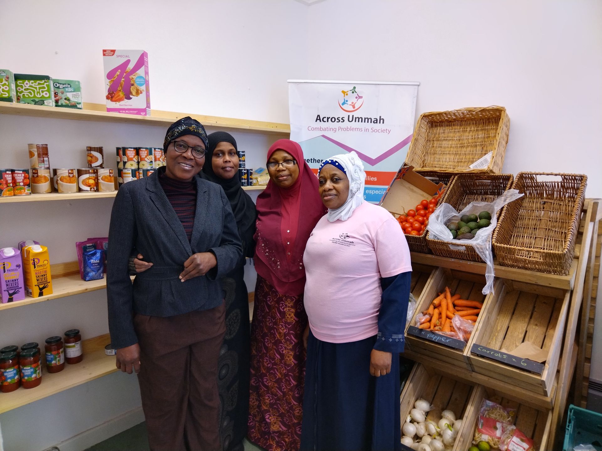 A group of women are posing for a picture in front of a grocery store.