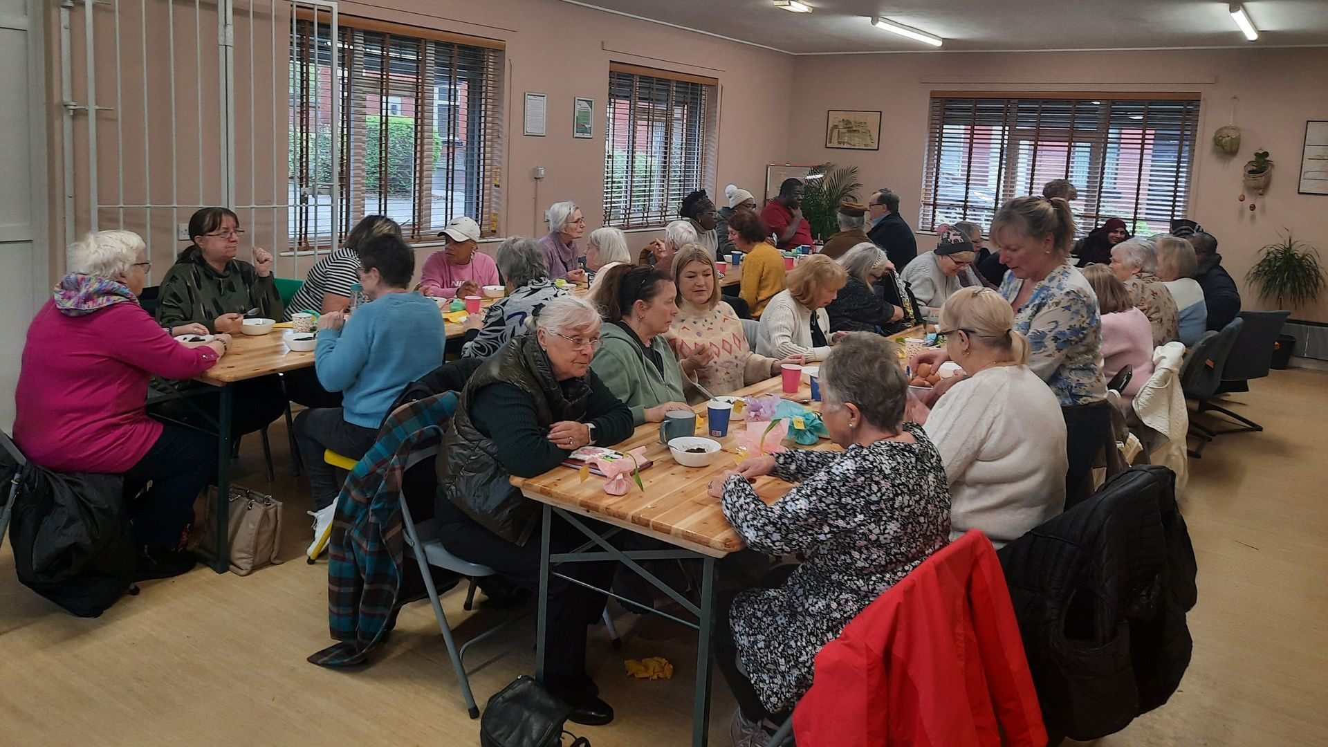 A group of people are sitting at tables in a room.
