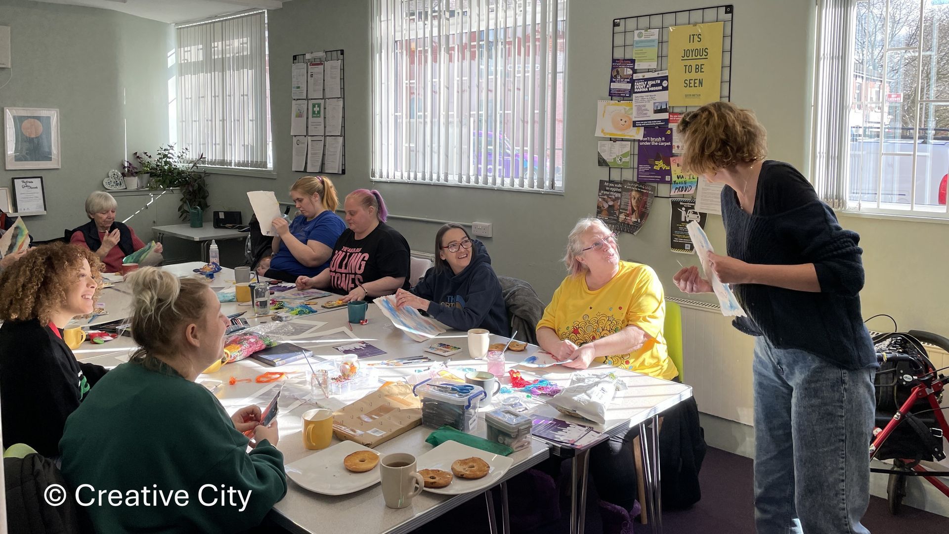 A group of people are sitting around a table in a room.