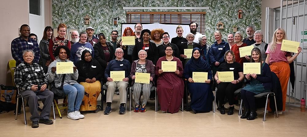 A group of people are posing for a picture while holding certificates.
