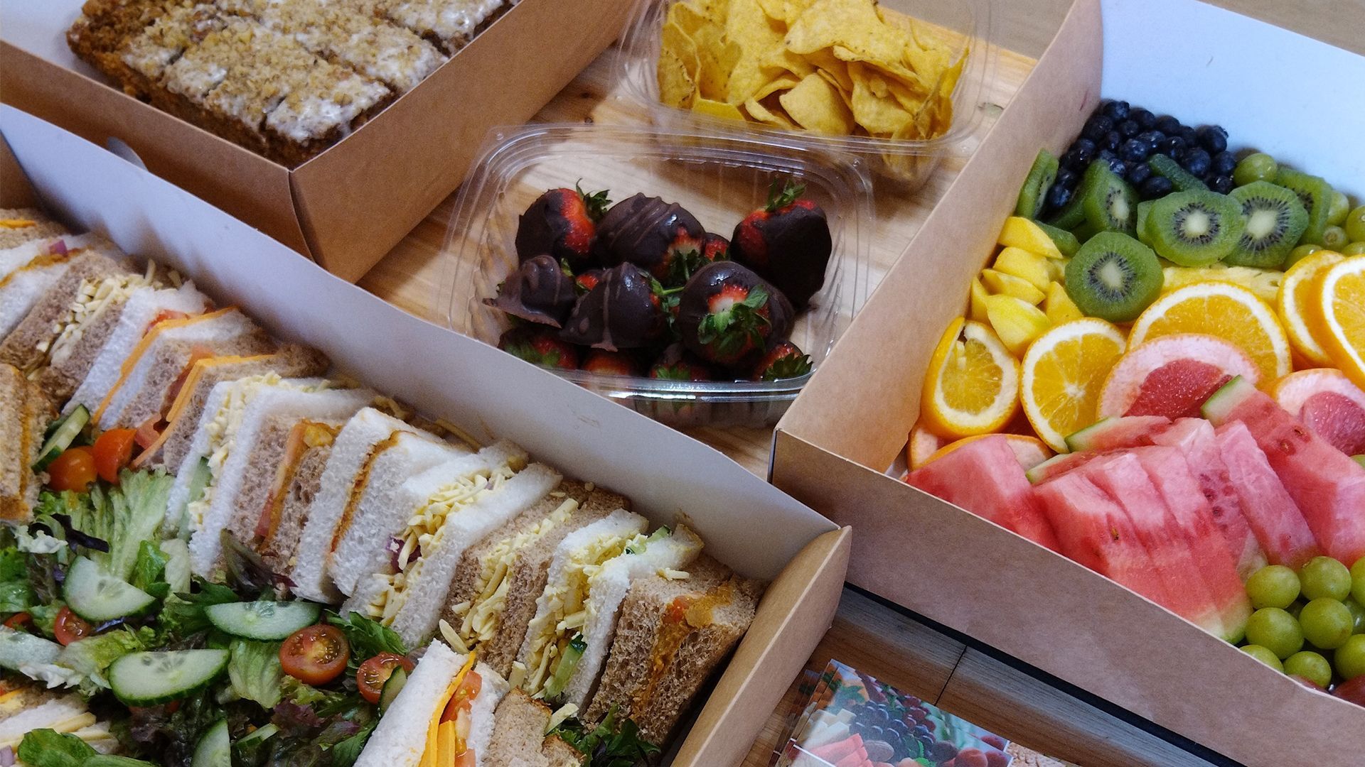A greenhouse is sitting in the middle of a lush green field surrounded by trees.