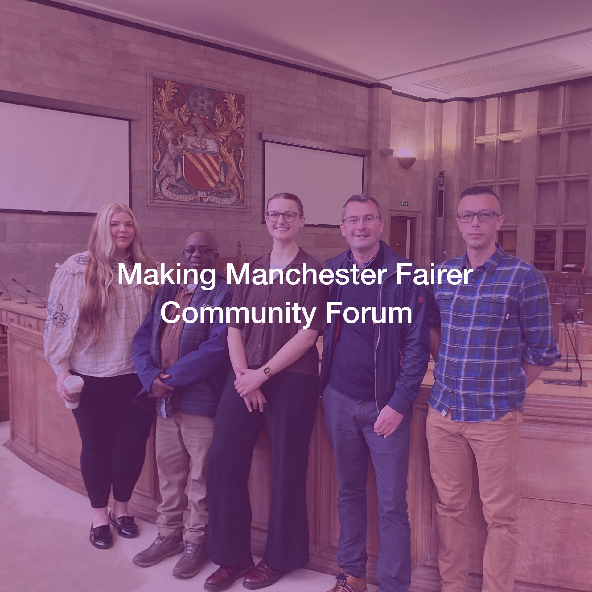 A group of people standing next to each other in a room.