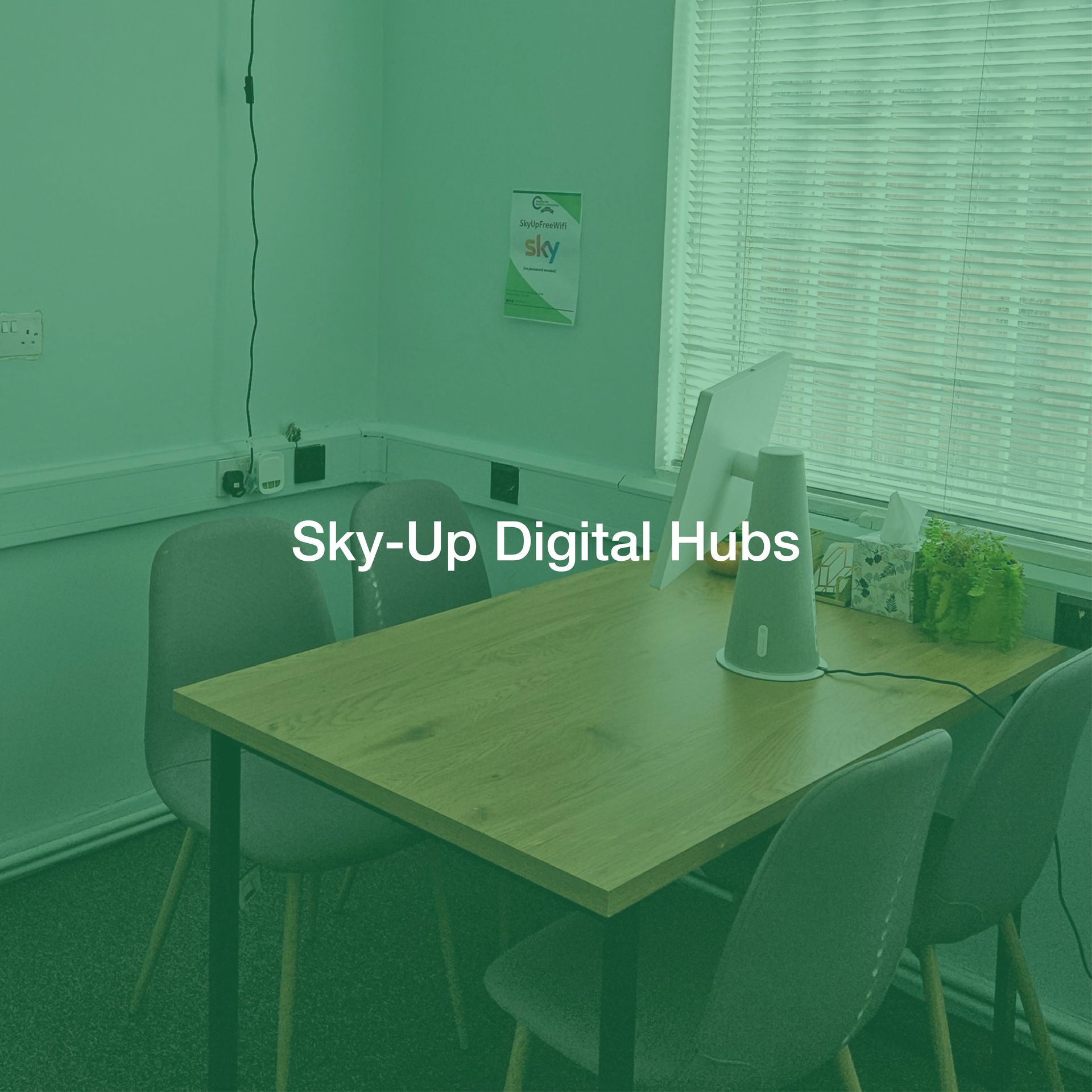 A green room with a table and chairs and the words sky-up digital hubs on the bottom