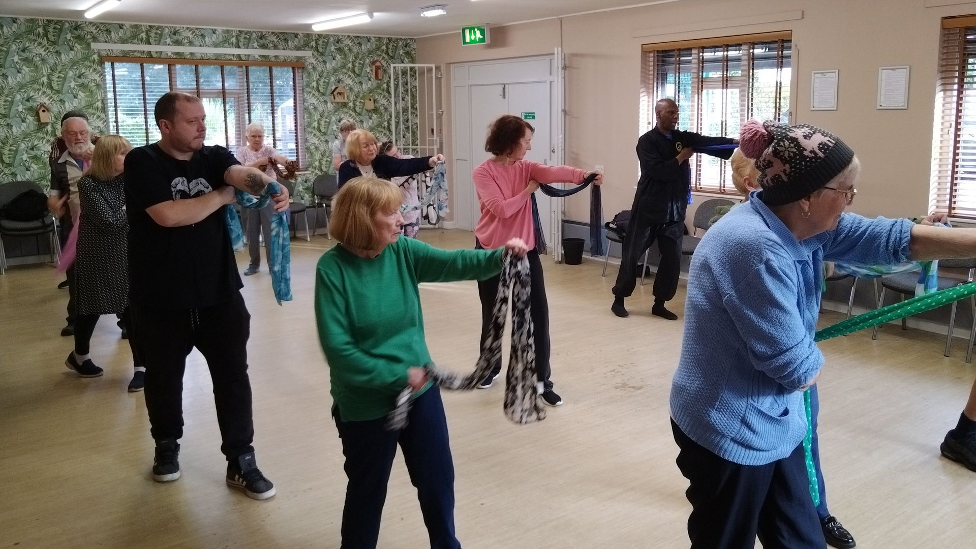 A group of people are doing exercises in a room.