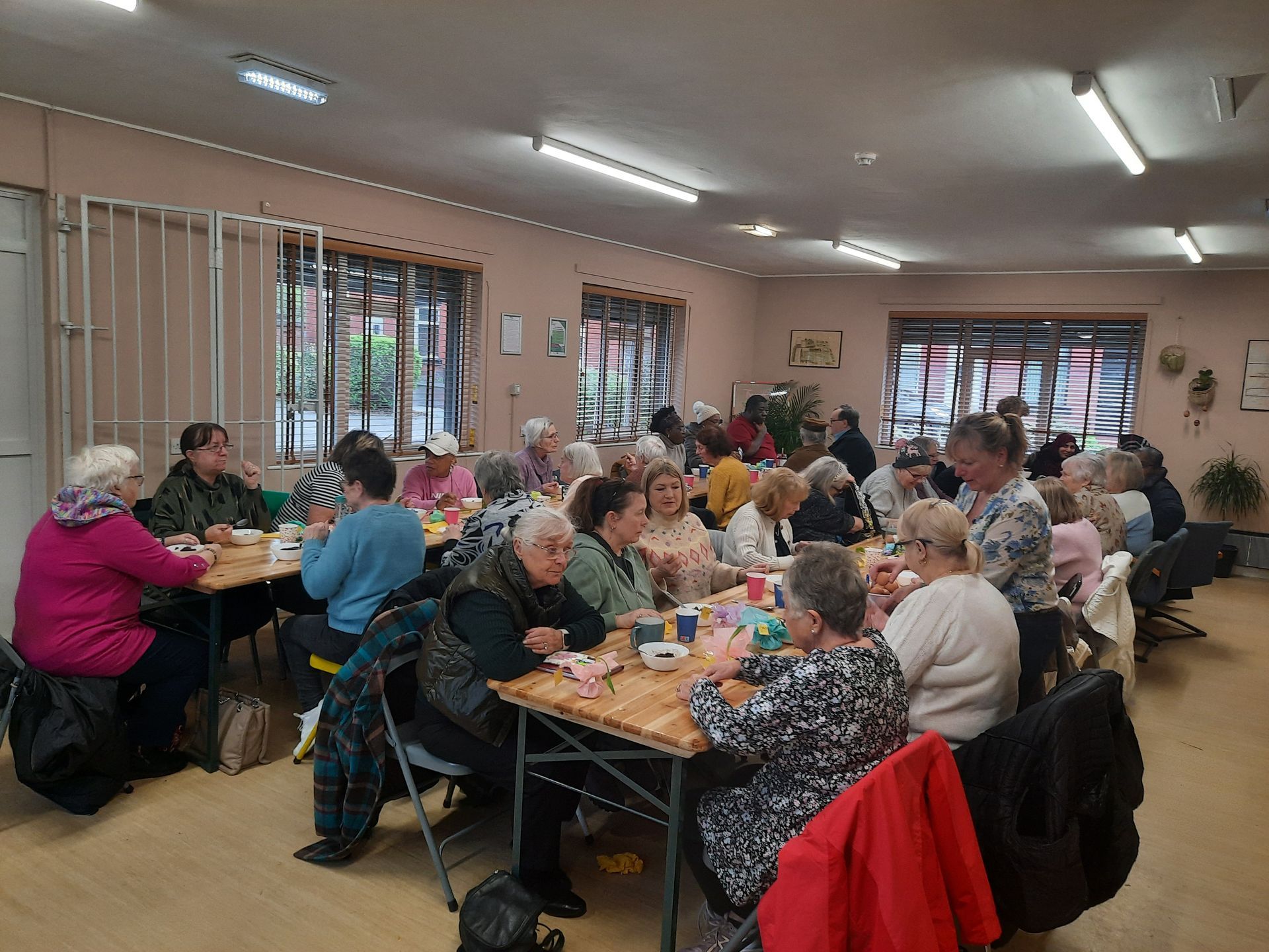A large group of people are sitting at tables in a room.
