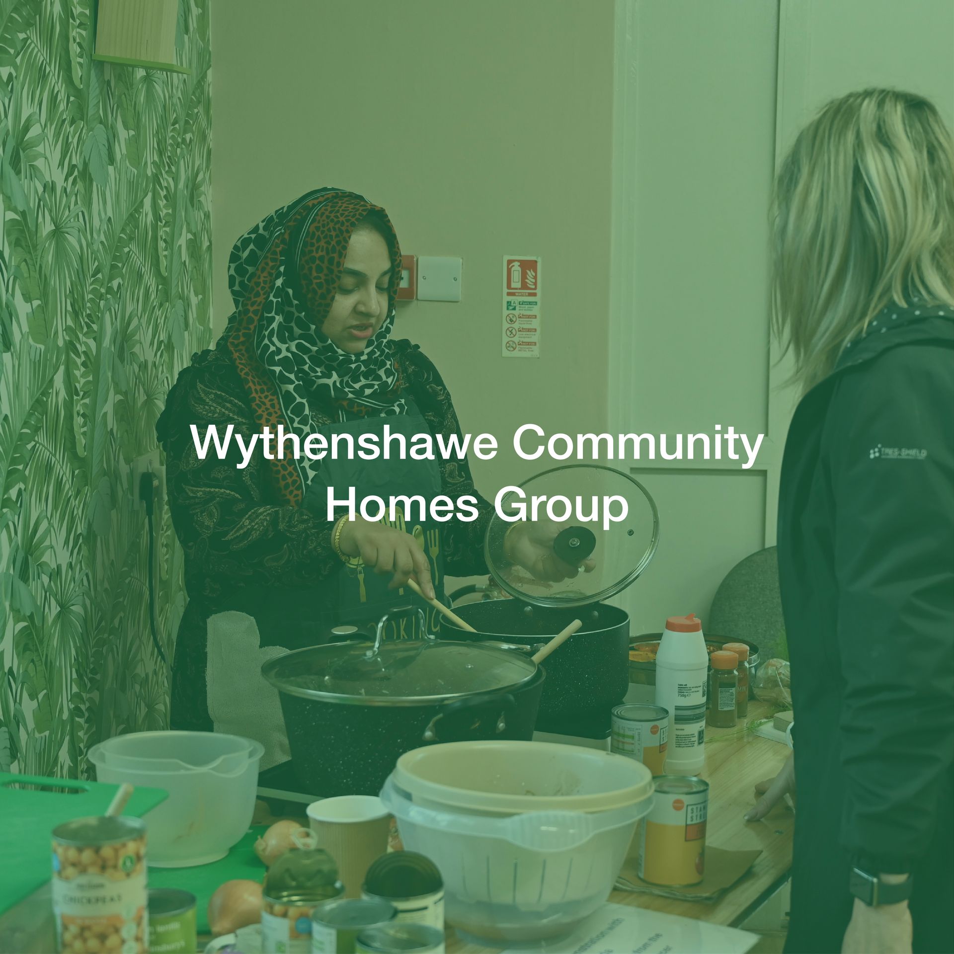 Wythenshawe community homes group is a group of people cooking together.