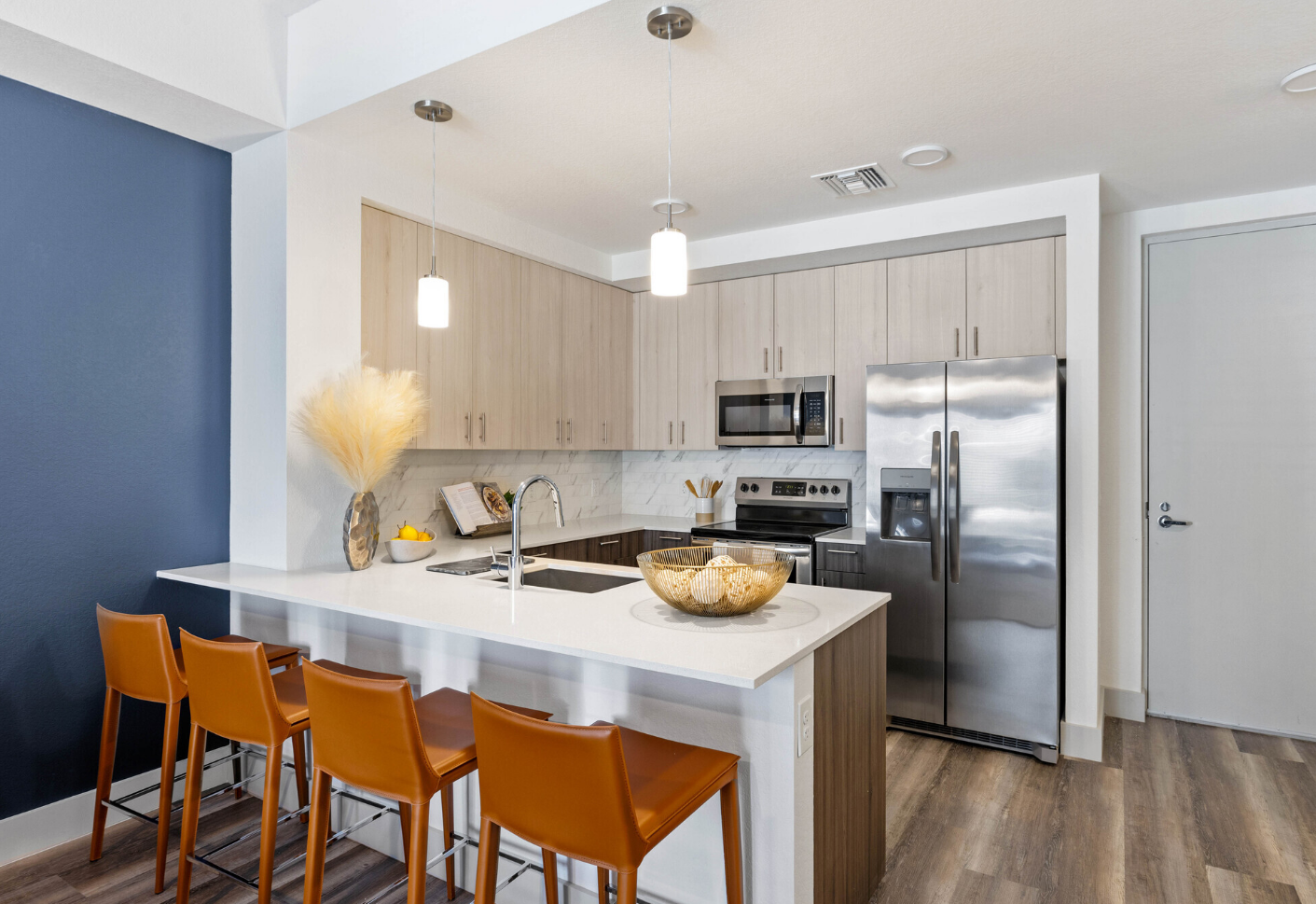 photo showing a kitchen with barstool area and