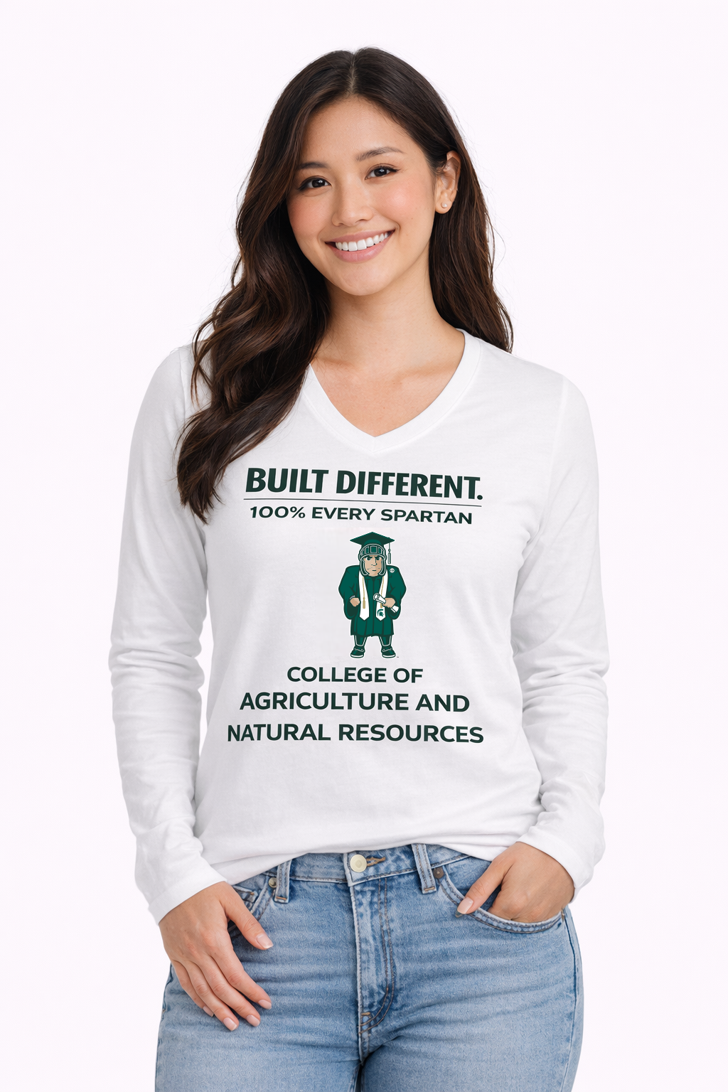 Woman wearing a white long-sleeve shirt and jeans, smiling against a light background.