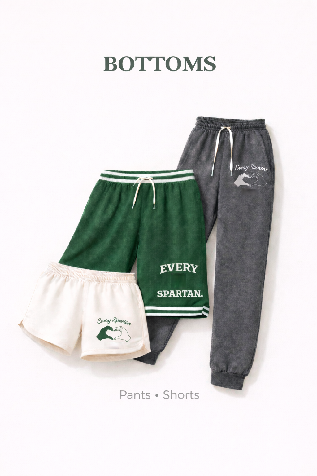 Three pairs of bottoms: cream shorts, green shorts, and grey sweatpants with drawstrings.