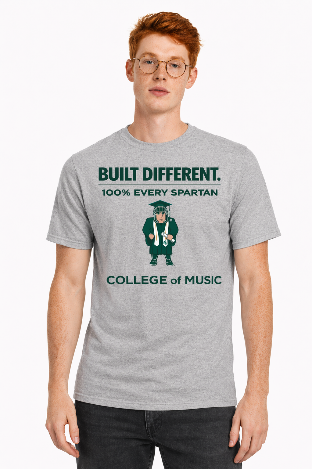 Model wearing a gray T-shirt with green text and graphic reading “BUILT DIFFERENT. 100% EVERY SPARTAN. COLLEGE OF MUSIC.”