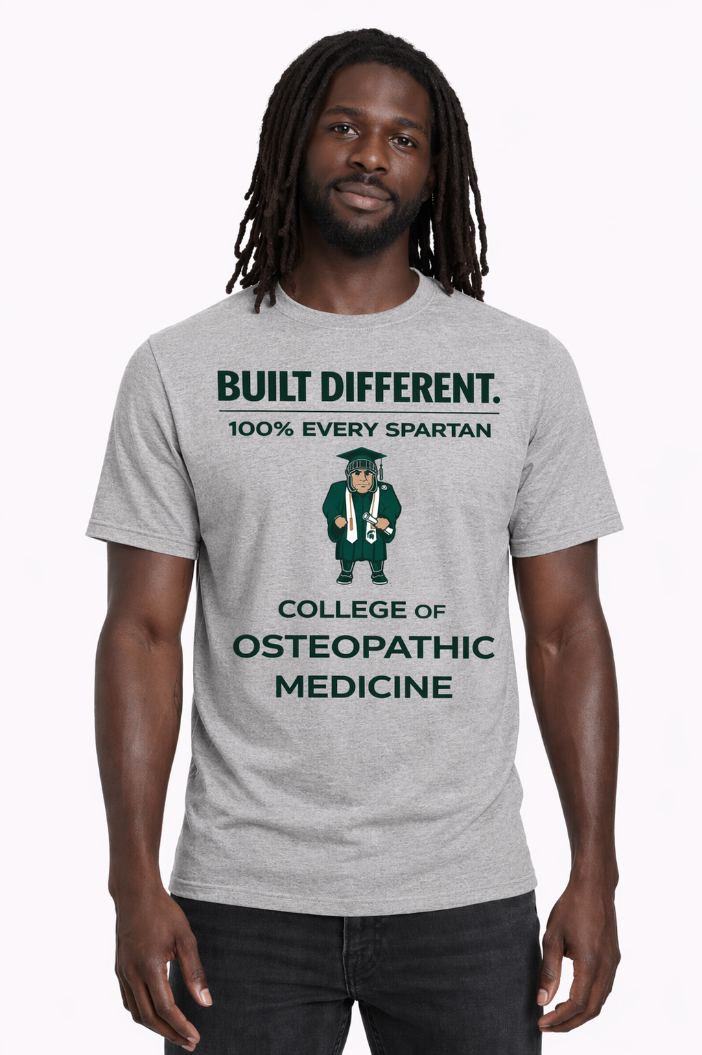 Man wearing a gray “Built Different” College of Osteopathic Medicine T-shirt against a white background