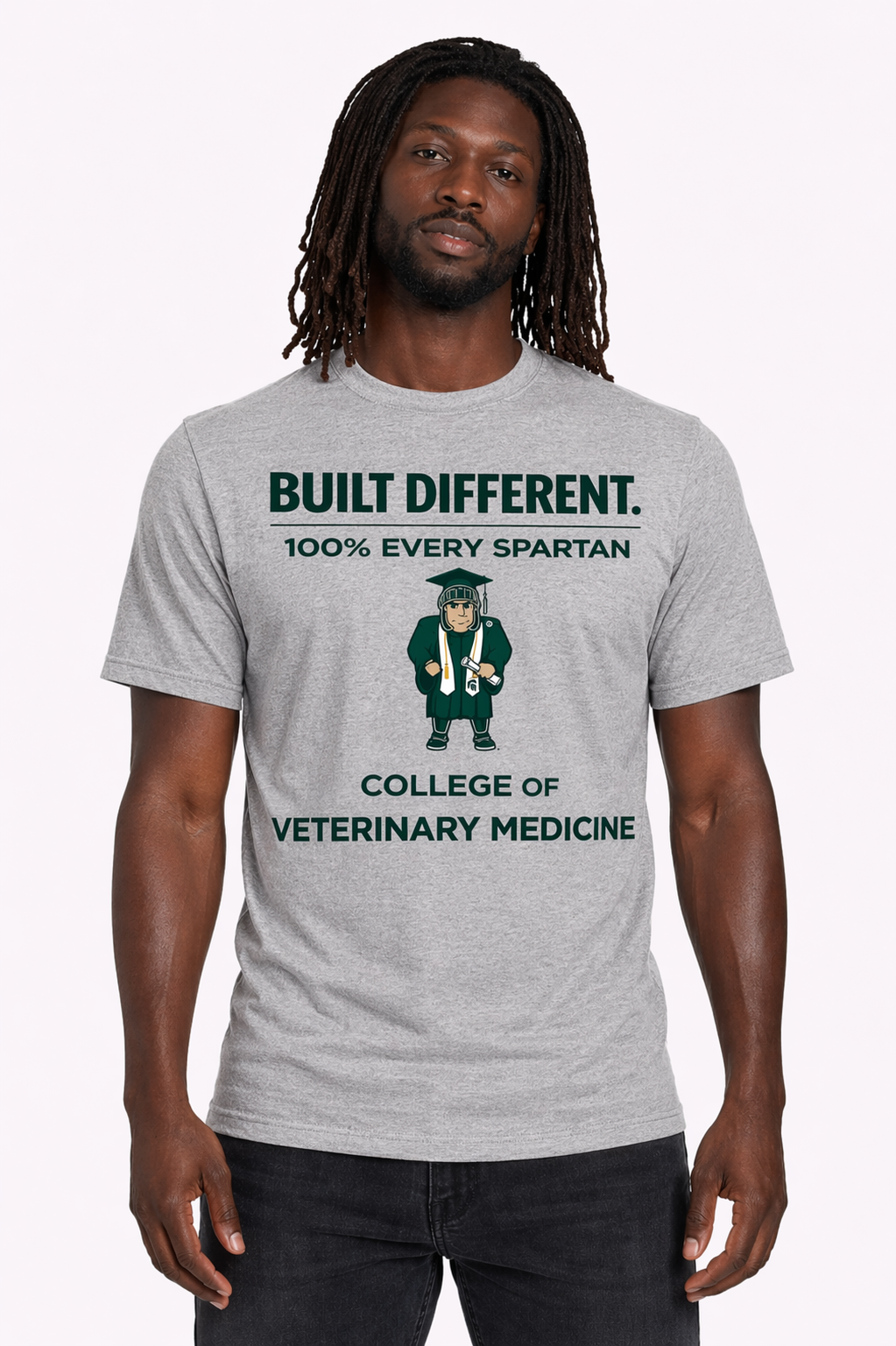 Man wearing a gray “Build Different” College of Veterinary Medicine T-shirt against a white background