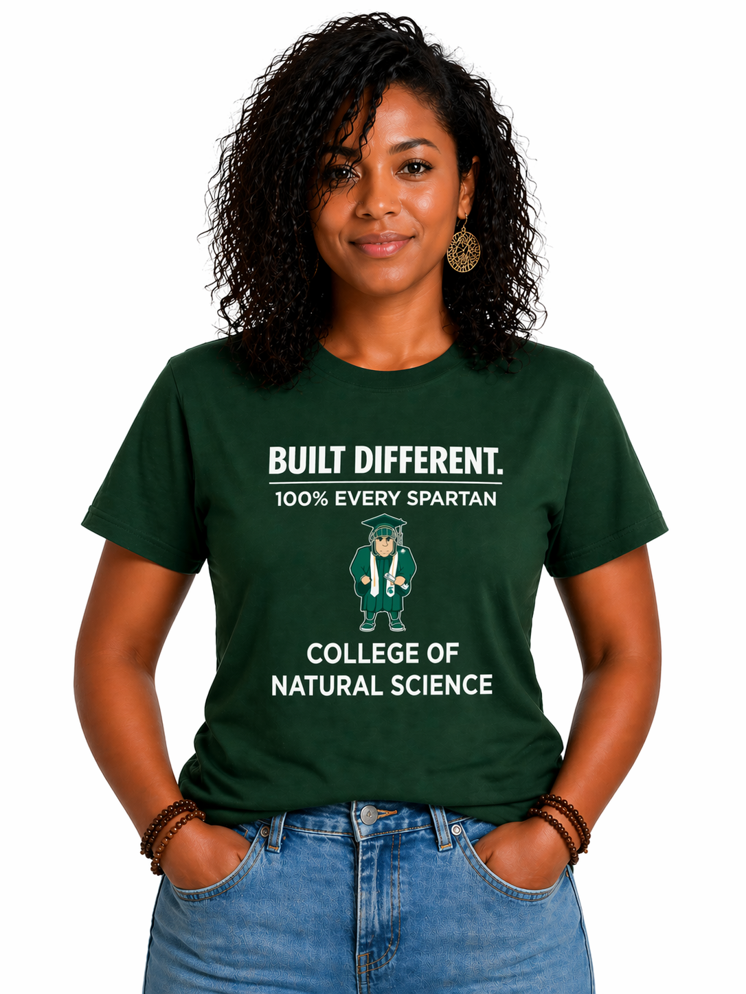 Person wearing a green “Built Different” College of Natural Science T-shirt and jeans, standing against a white background