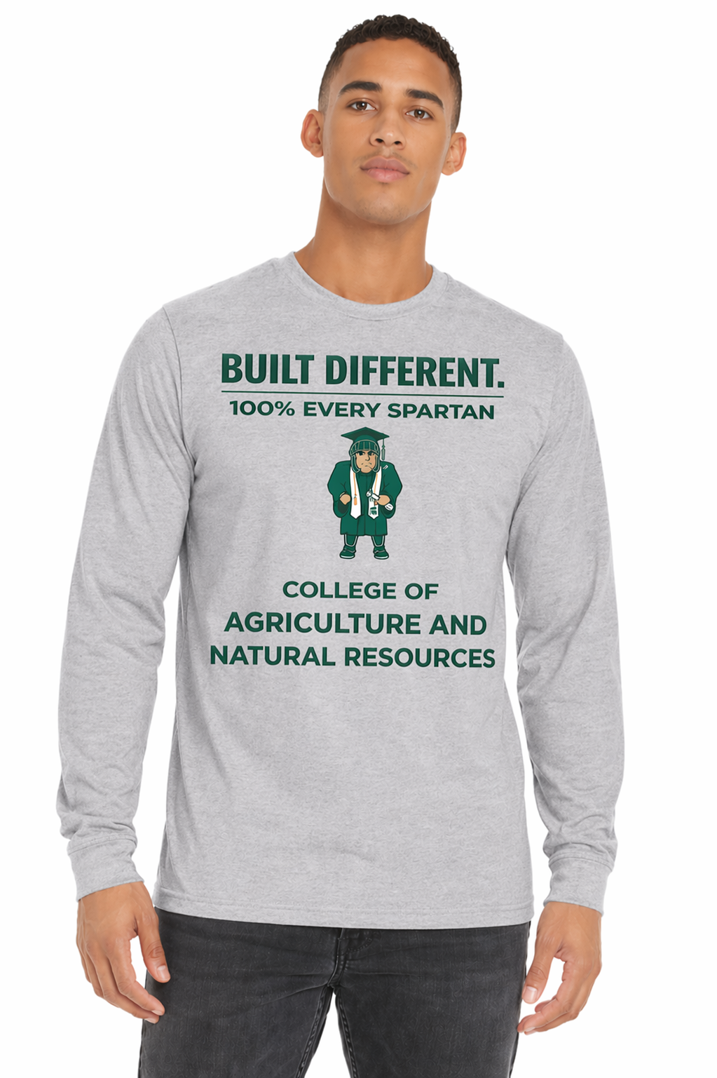 Man wearing a gray long-sleeve shirt with green college graphics and text, standing against a white background