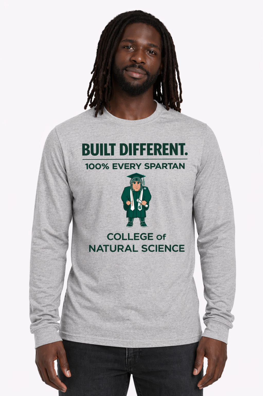 Gray long-sleeve shirt with “Built Different” text and a central graphic worn by a person standing against a white background