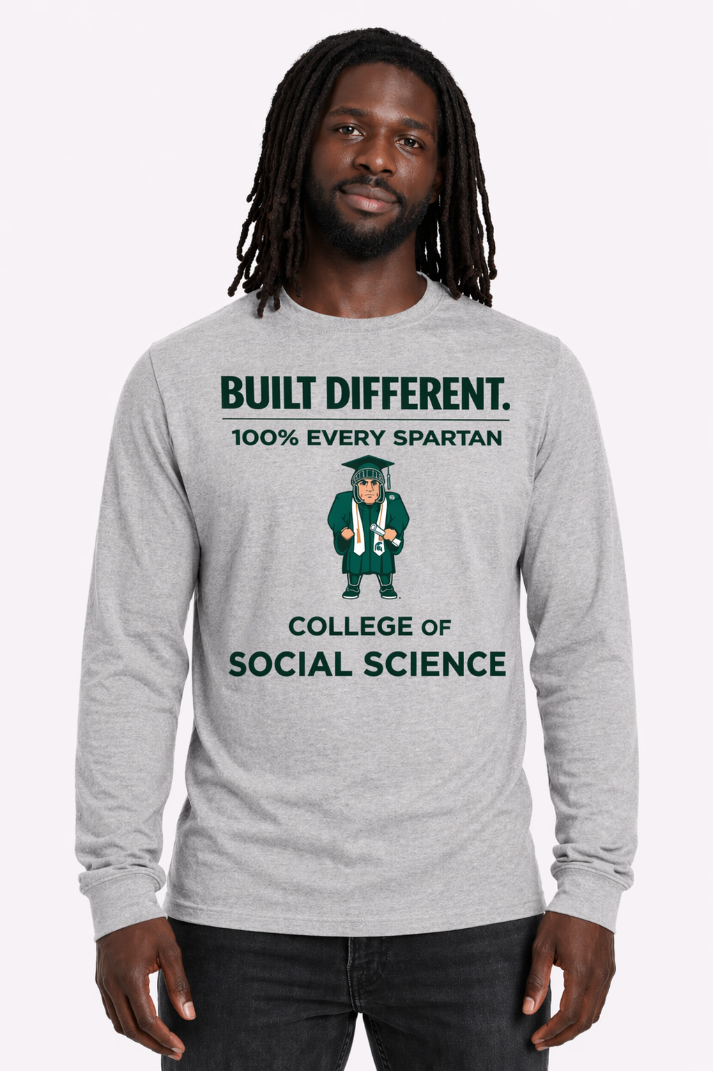 Man wearing a gray long-sleeve shirt with green “Built Different” and “College of Social Science” text and graphic