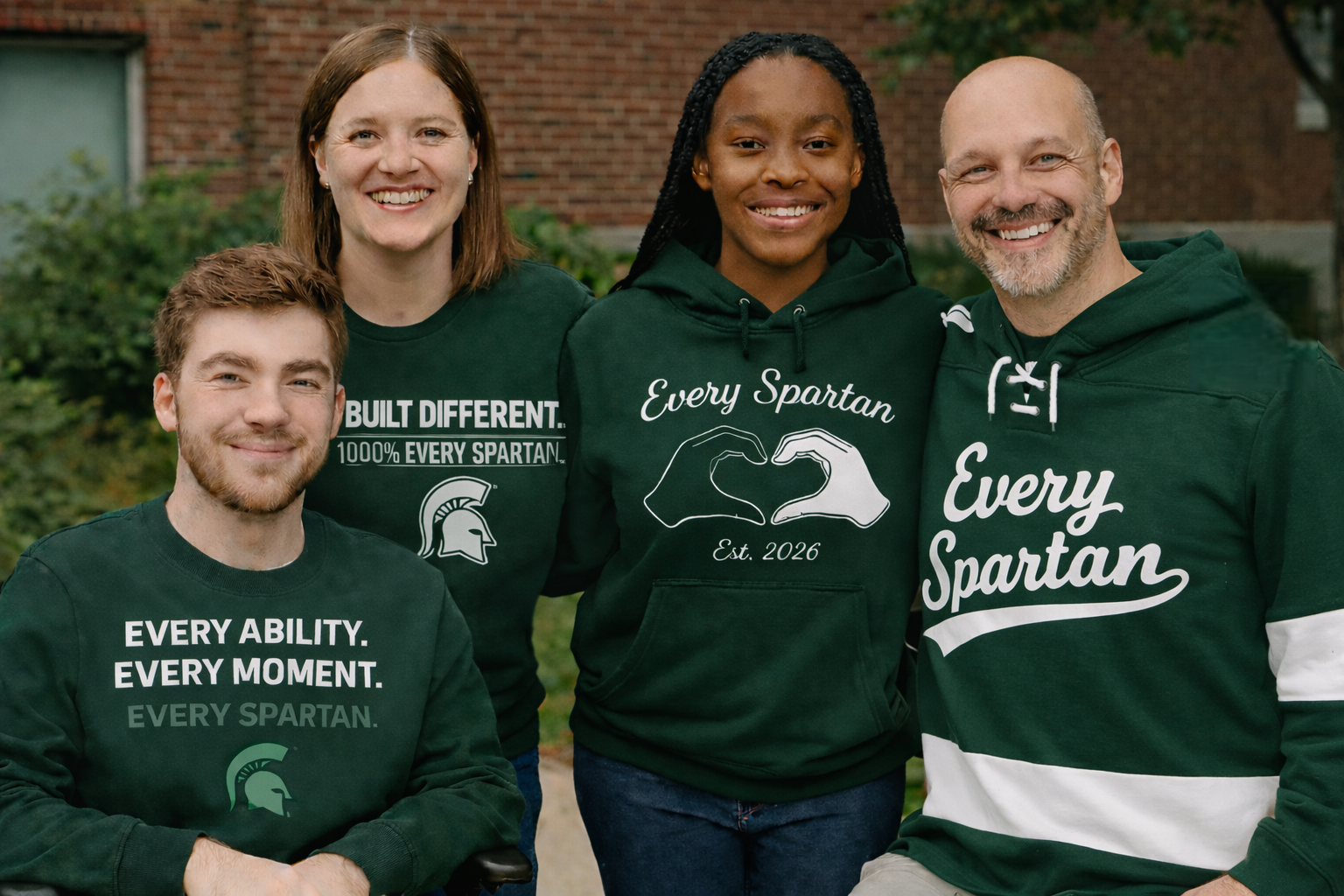 Four people wearing green sweatshirts. 