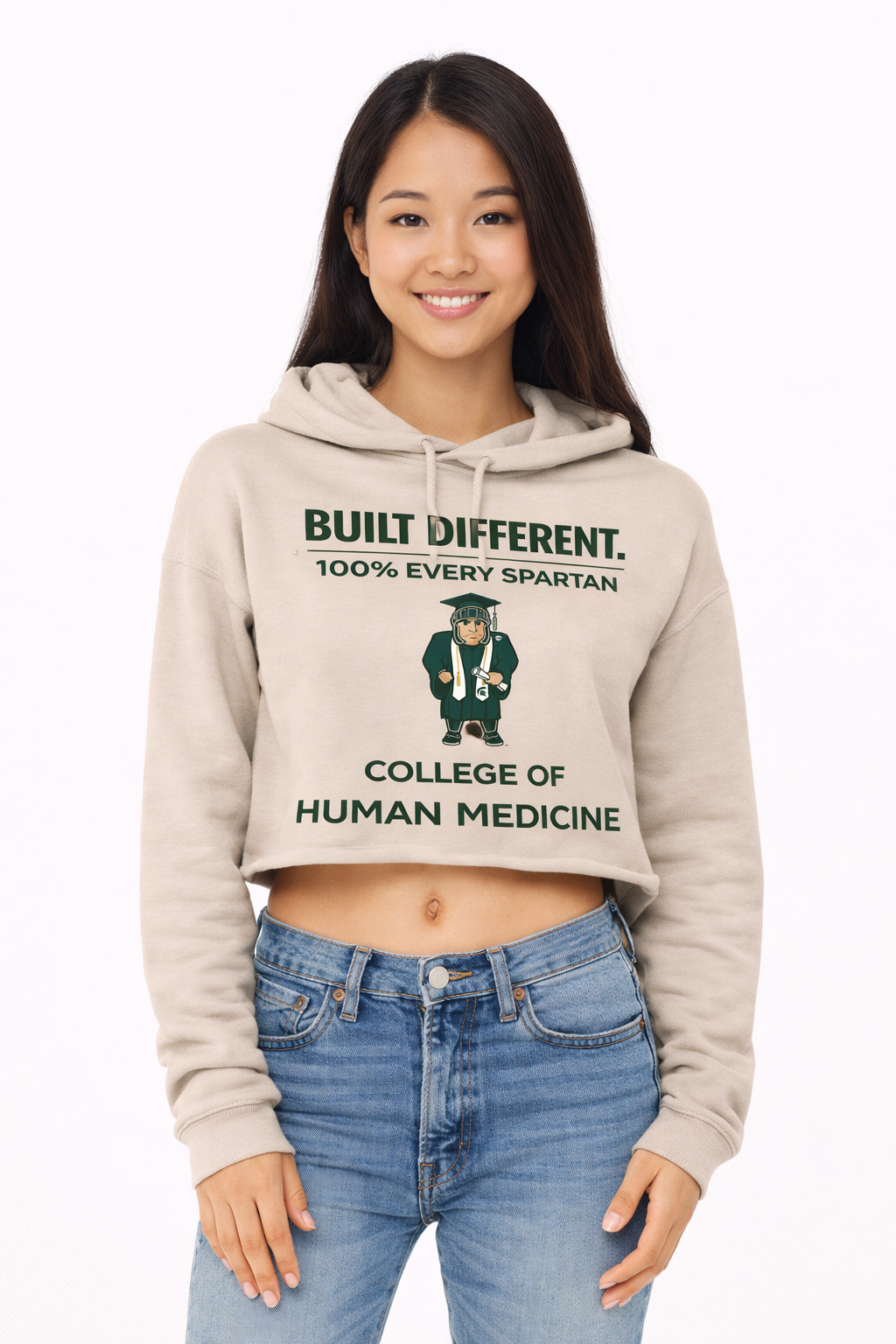 A person wears a beige cropped hoodie with 