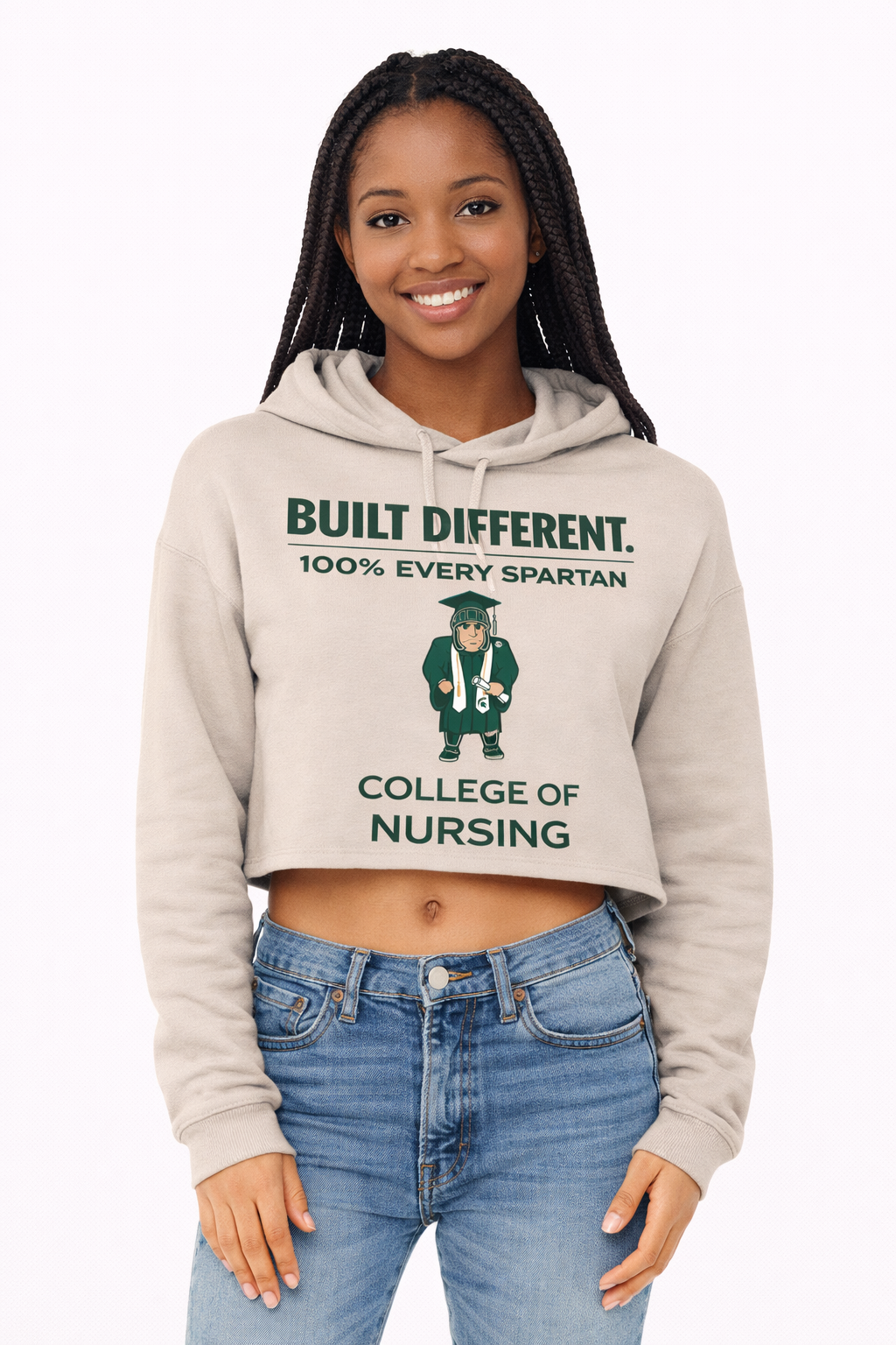 A cropped tan hoodie featuring green text that reads 