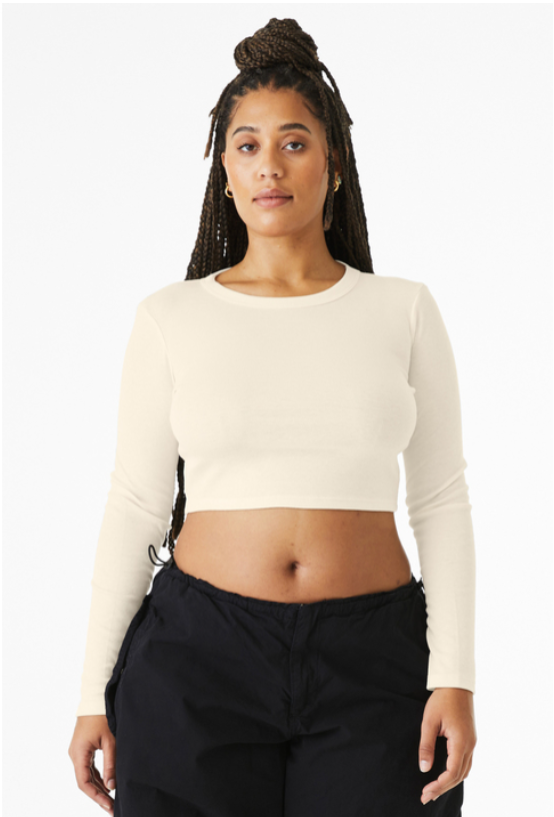 Cream-colored long-sleeved crop top with green text and a Spartan logo.