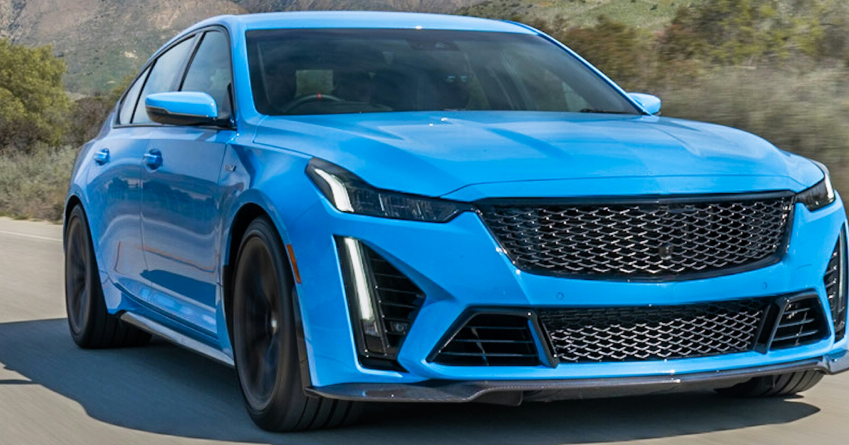 Blue Cadillac CT5-V Blackwing sedan on a road, black grille and wheels.